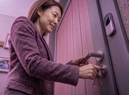 Woman locking her front door